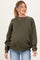 woman wearing a dark green maternity sweatshirt with a relaxed fit and long sleeves