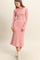 woman wearing a pink striped long sleeve midi dress with a flared hem and fitted bodice