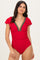 woman wearing a red swimsuit with a colorful v-neckline and ruffled sleeves