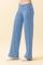 woman wearing light blue wide leg pants with a high waist and a relaxed fit
