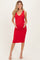 woman wearing a red fitted maternity dress with a v-neckline and holding her baby bump