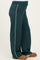 woman wearing teal maternity lounge pants with white side stripes and cozy slippers