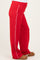maternity wear red sweatpants with white side stripes, fitted at the waist, model wearing them with a visible baby bump