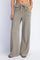 woman wearing olive green wide-leg ribbed pants with front pockets and a drawstring waist