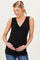 woman wearing a black sleeveless maternity top with a v-neck and wrapped bodice, cradling her baby bump