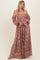 woman wearing a blush pink off-the-shoulder lace maxi dress with long puff sleeves and a fitted bodice