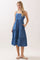 woman wearing a blue tiered midi dress with adjustable straps and pockets