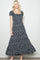 woman wearing a navy blue floral maxi dress with short puff sleeves and a square neckline