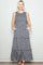 woman wearing a navy blue floral maxi dress with tiered skirt and pockets