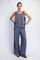 woman wearing a gray sleeveless top and loose-fitting gray wide-leg pants