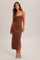 woman wearing a brown ribbed knit maxi dress with lace trim straps and strappy sandals