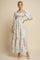 woman wearing a long floral print maxi dress with puff sleeves and a tiered skirt