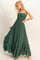 woman wearing a dark green maxi dress with a smocked bodice and tiered ruffle hem