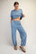 woman wearing a light blue cropped t-shirt and matching relaxed-fit sweatpants