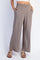 woman wearing taupe wide-leg pants with an elastic waistband and side pockets
