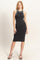 woman wearing a fitted black midi dress with white trim and a racerback style, standing on a neutral background