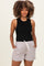 woman wearing a black sleeveless top and striped maternity shorts with an elastic waist and side pockets
