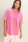 woman wearing a loose fit pink oversized t-shirt with a chest pocket