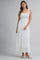 woman wearing a white pleated maxi dress with a square neckline and a tie shoulder detail