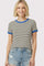 woman wearing a striped short sleeve t-shirt with blue ribbed neckline and cuffs, paired with denim shorts