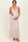 woman wearing a sparkly light pink halter neck maternity dress with a keyhole detail and baby bump visible