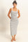 woman wearing a black and white striped tank maxi dress with side pockets