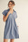 woman wearing a light blue short sleeve polo dress with a v-neck and pockets