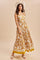 woman wearing a mustard yellow floral maxi dress with a fitted bodice and flowing skirt, accessorized with a straw hat
