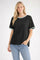 woman wearing a black short sleeve t-shirt with teal trim and light blue jeans