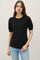 woman wearing a black short sleeve top with puffed sleeves and a relaxed fit, paired with light blue jeans