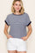 woman wearing a navy and white striped short sleeve top with rolled cuffs and white shorts