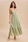 woman wearing a light green maxi dress with lace detailing and a tiered skirt