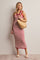 woman wearing a red and white striped ribbed midi dress, holding a straw bag and wearing beige slide sandals