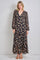 woman wearing a black floral maxi dress with long sleeves and tiered ruffles