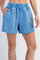 woman wearing light blue sweat shorts with an elastic waistband and side pockets
