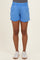 woman wearing light blue maternity shorts with an elastic waistband and side pockets