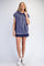 woman wearing a cropped navy blue sleeveless hoodie with a front pocket and white drawstrings, paired with a navy blue skirt