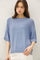 woman wearing a light blue oversized sweater with short sleeves and ribbed detailing