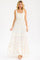 woman wearing a white floral maxi dress with a square neckline and tiered skirt