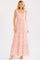 woman wearing a pink floral maxi dress with a square neckline and tiered skirt