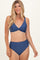 woman wearing a navy blue bikini top with a twisted front and high-waisted bikini bottom