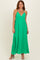 woman wearing a vibrant green maxi dress with a plunging neckline and adjustable spaghetti straps