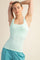 woman wearing a light mint green fitted tank top with wide straps and a square neckline