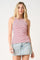 woman wearing a red and white striped sleeveless tank top with a high neckline and a denim mini skirt