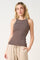 woman wearing a brown and cream striped fitted tank top with a high neckline and athletic style