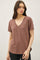 woman wearing a dusty rose v-neck t-shirt with short sleeves and a relaxed fit