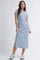 woman wearing a light blue short sleeve maxi dress and white sneakers