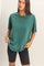 woman wearing a green oversized t-shirt and black bike shorts