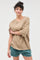 woman wearing a beige oversized t-shirt with short sleeves and styled in a casual look