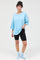 woman wearing a light blue oversized t-shirt and black biker shorts with pastel blue socks